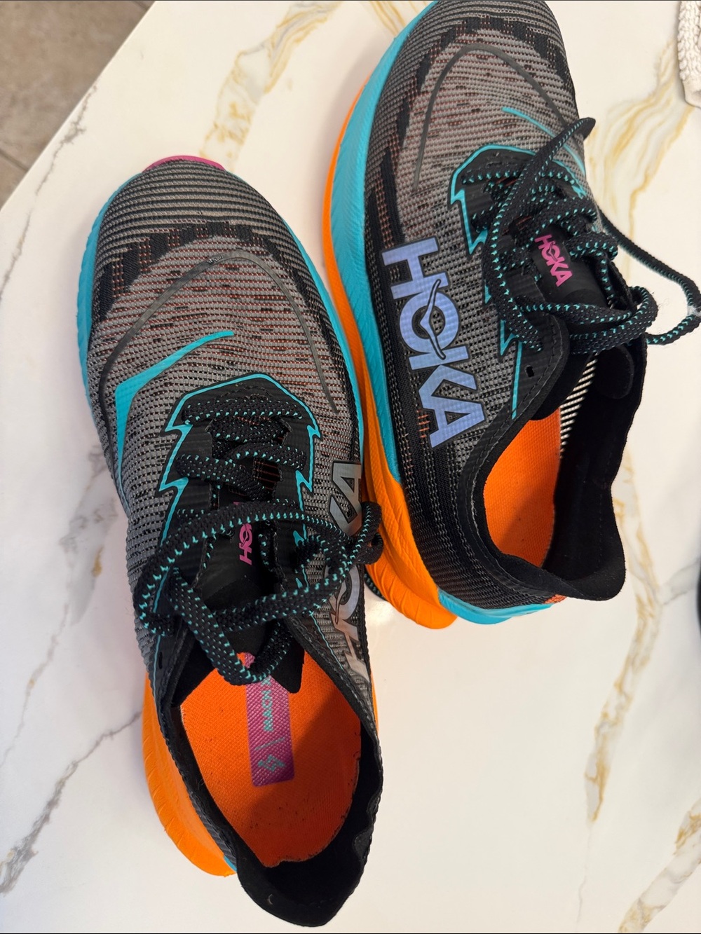 HOKA women’s Lightweight Running Shoes - Gray with Orange & Teal Accents.
